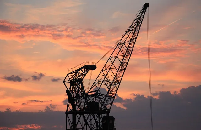 harbor crane, sunset, heaven, clouds, industry, nature, port, mood, crane, shipping, evening atmosphere, dusk, loading crane, freight transport, evening sky, transport, harbor romance, afterglow, red sky, evening glow, eve, reddish, atmospheric. Belfast and the dual market, seller software for UK and EU trade from Northern Ireland